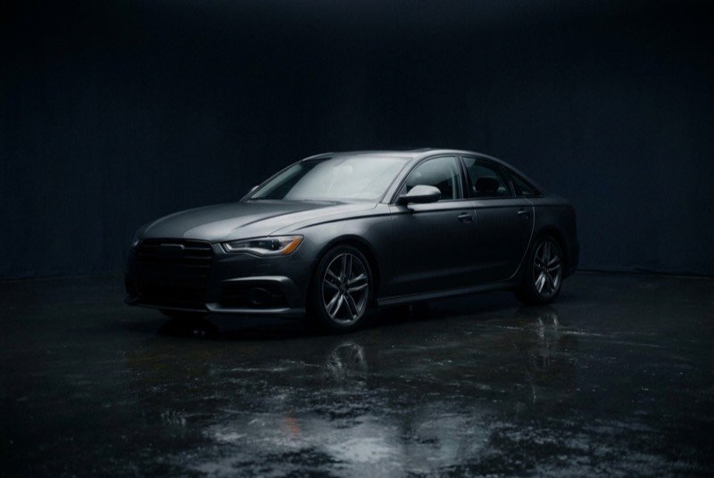 A dark sedan in a studio